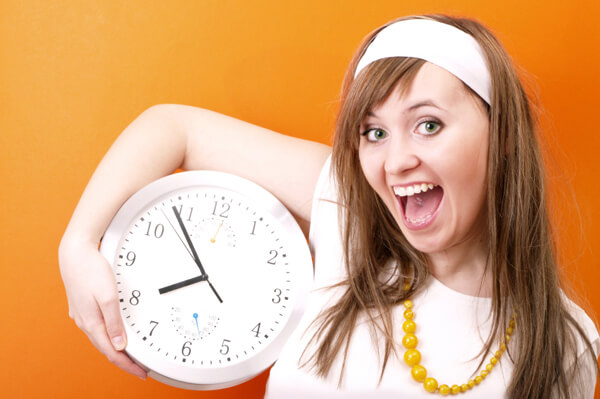 happy-woman-holding-clock